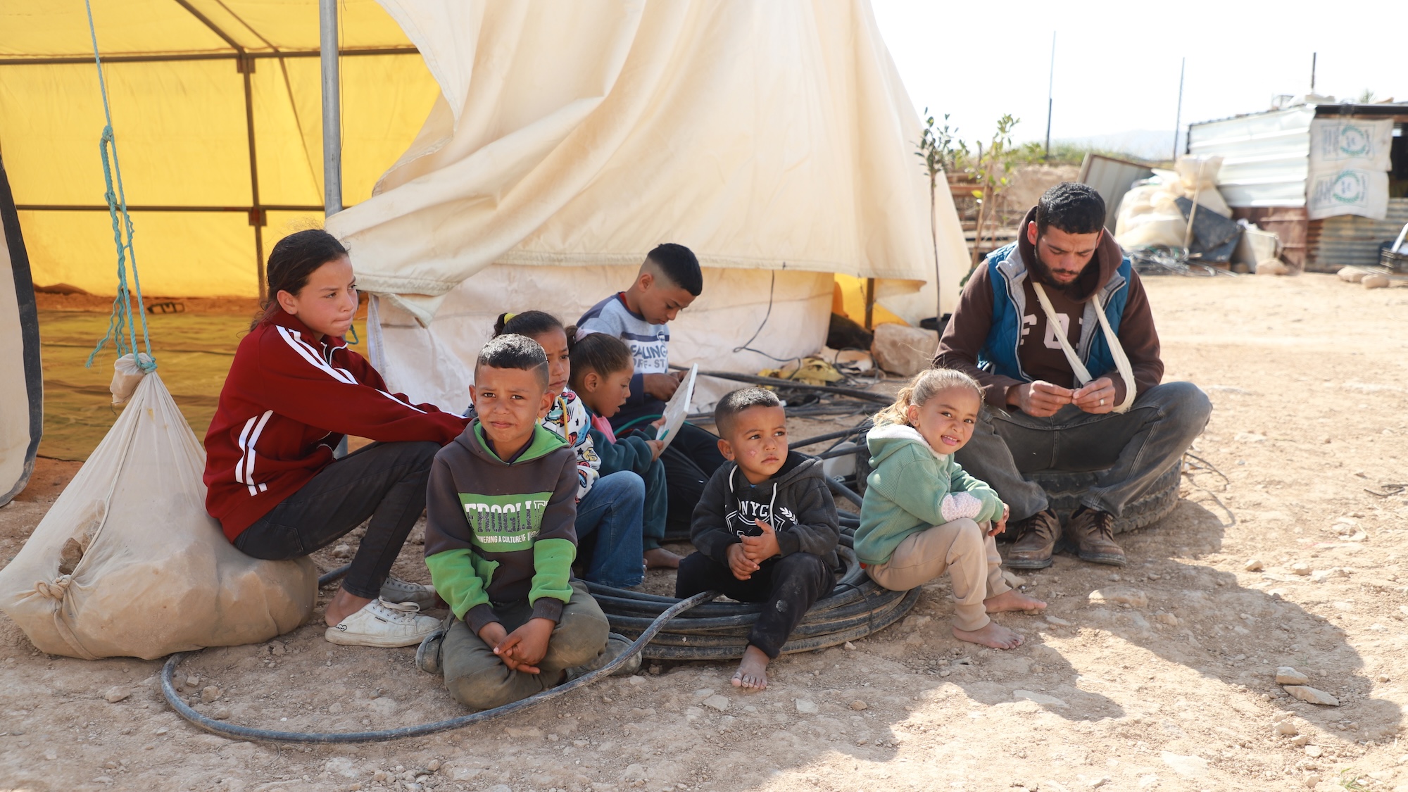 Haitham Rashaidh and his family are pictured in al-Balqa, where they have lived since their displacement from the Ein al-Auja area, near Jericho, on 10 April 2026 (MEE/Majd Jawad)