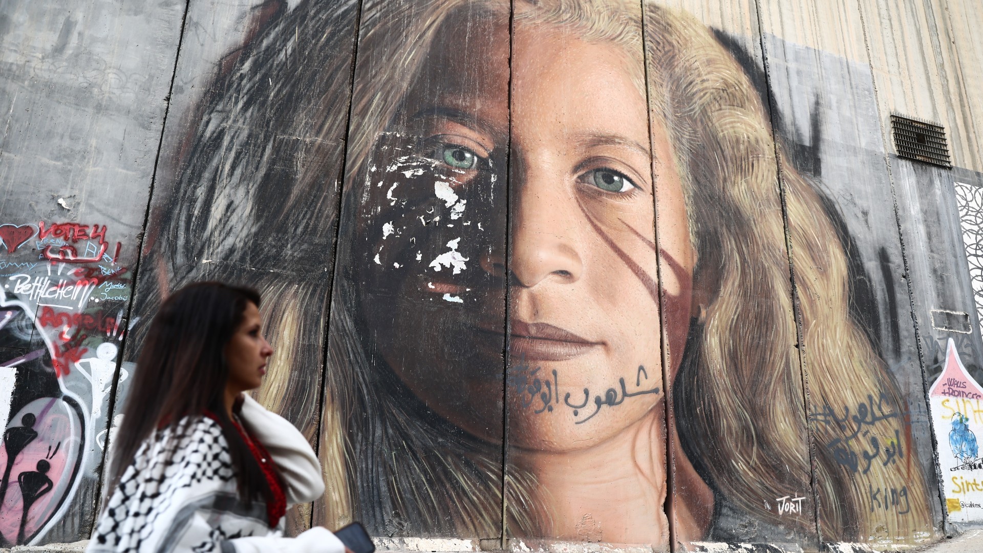 A person walks near the Israeli West Bank Barrier in Bethlehem, Palestinian Territories on December 28, 2022