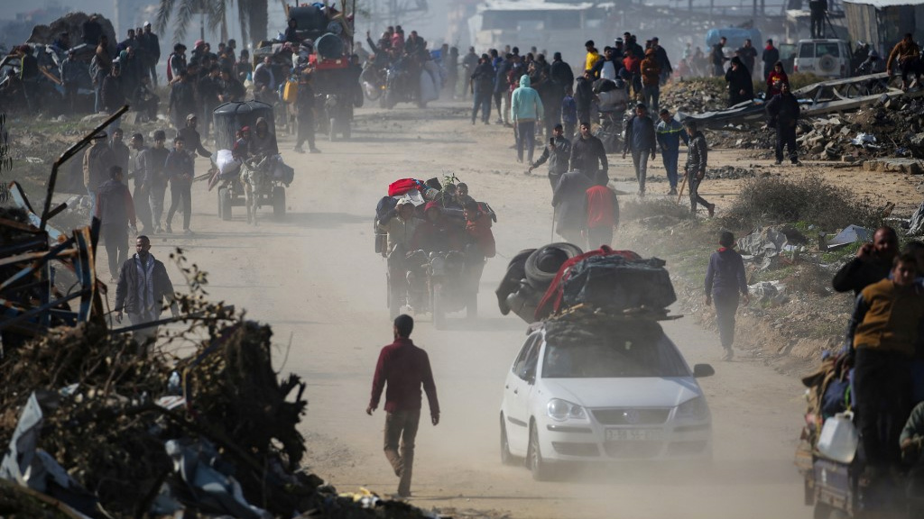 Displaced Palestinians walk towards Gaza City from the territory’s south on 27 January 2025 (Eyad Baba/AFP)