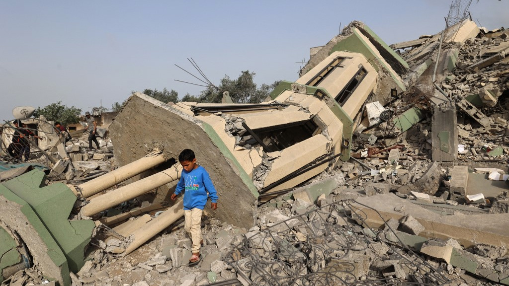 Palestinians inspect the rubble of a mosque destroyed in Israeli strikes at the Nuseirat refugee camp in the central Gaza Strip on 12 May 2025 (Eyad Baba/AFP)