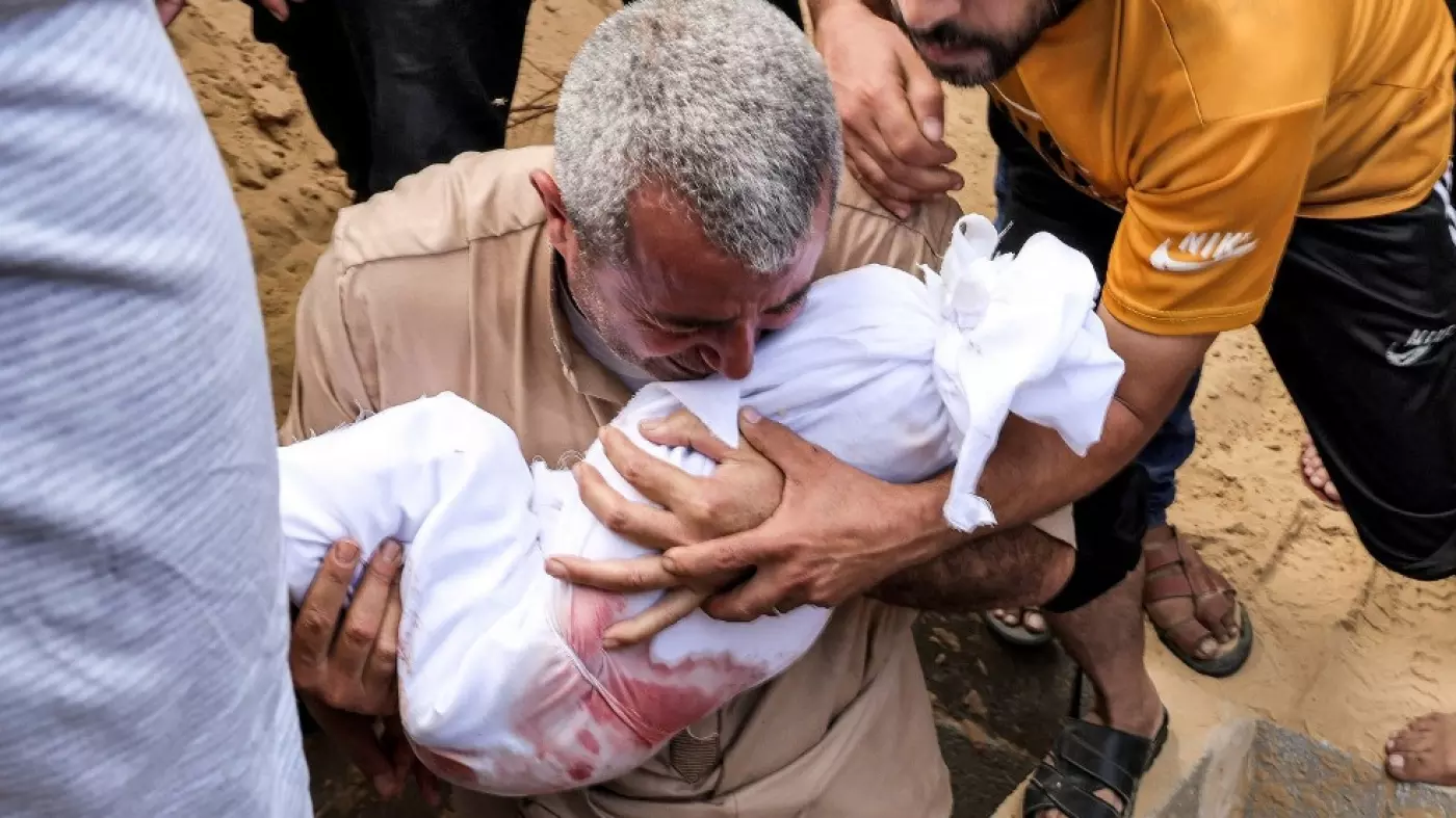 man holds body child khan younis gaza