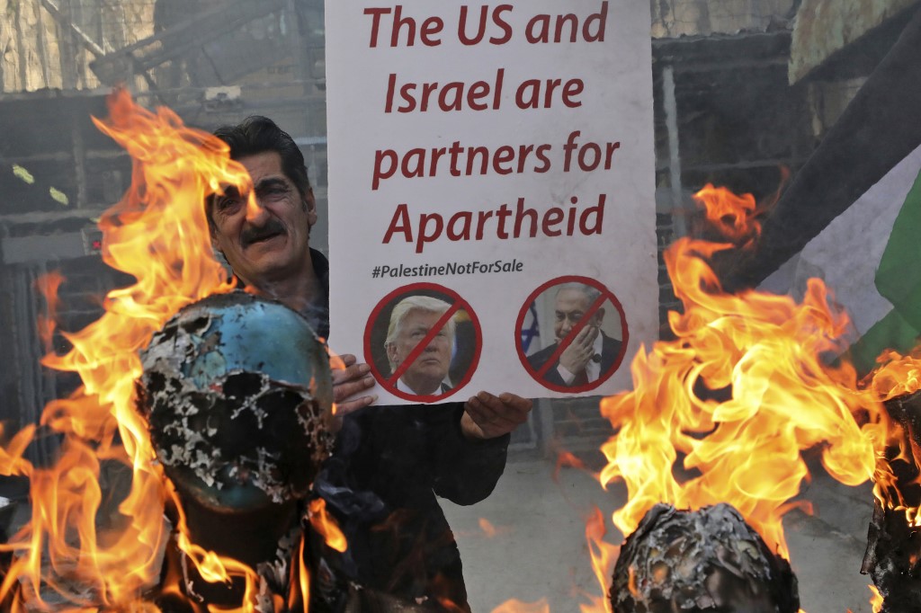 Palestinians protest against Trump’s Israel-Palestine plan in Hebron on 28 February (AFP)