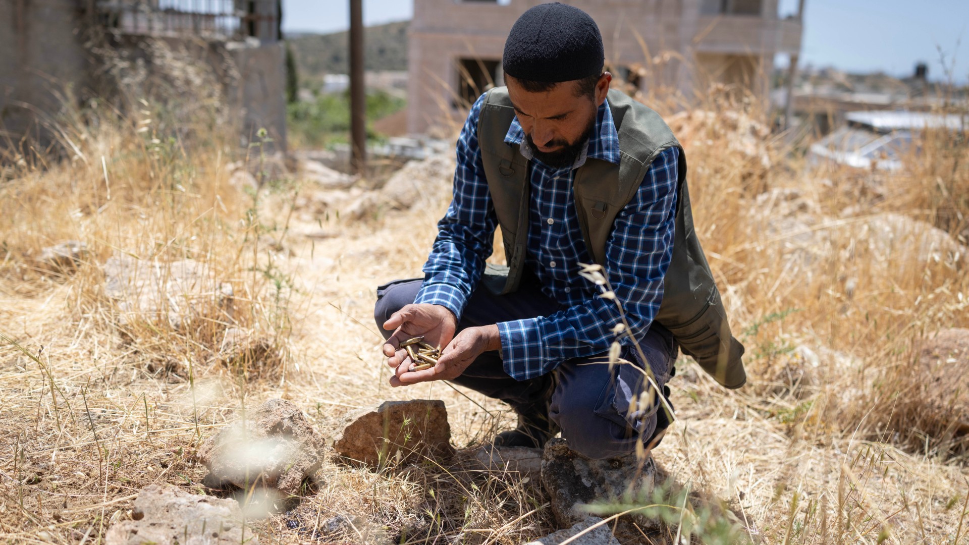 Palestinian Ali Kaabneh showing spent brass following an Israeli raid on his village (Oren Ziv/MEE)
