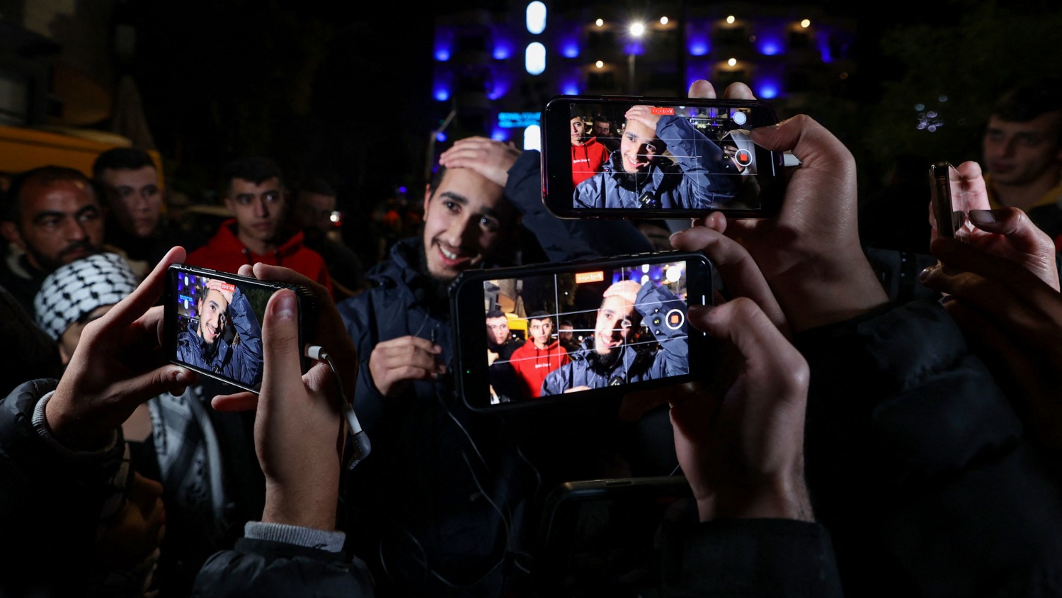 A newly released Palestinian prisoner gestures amid supporters during a welcome ceremony in Ramallah on 1 December 2023.