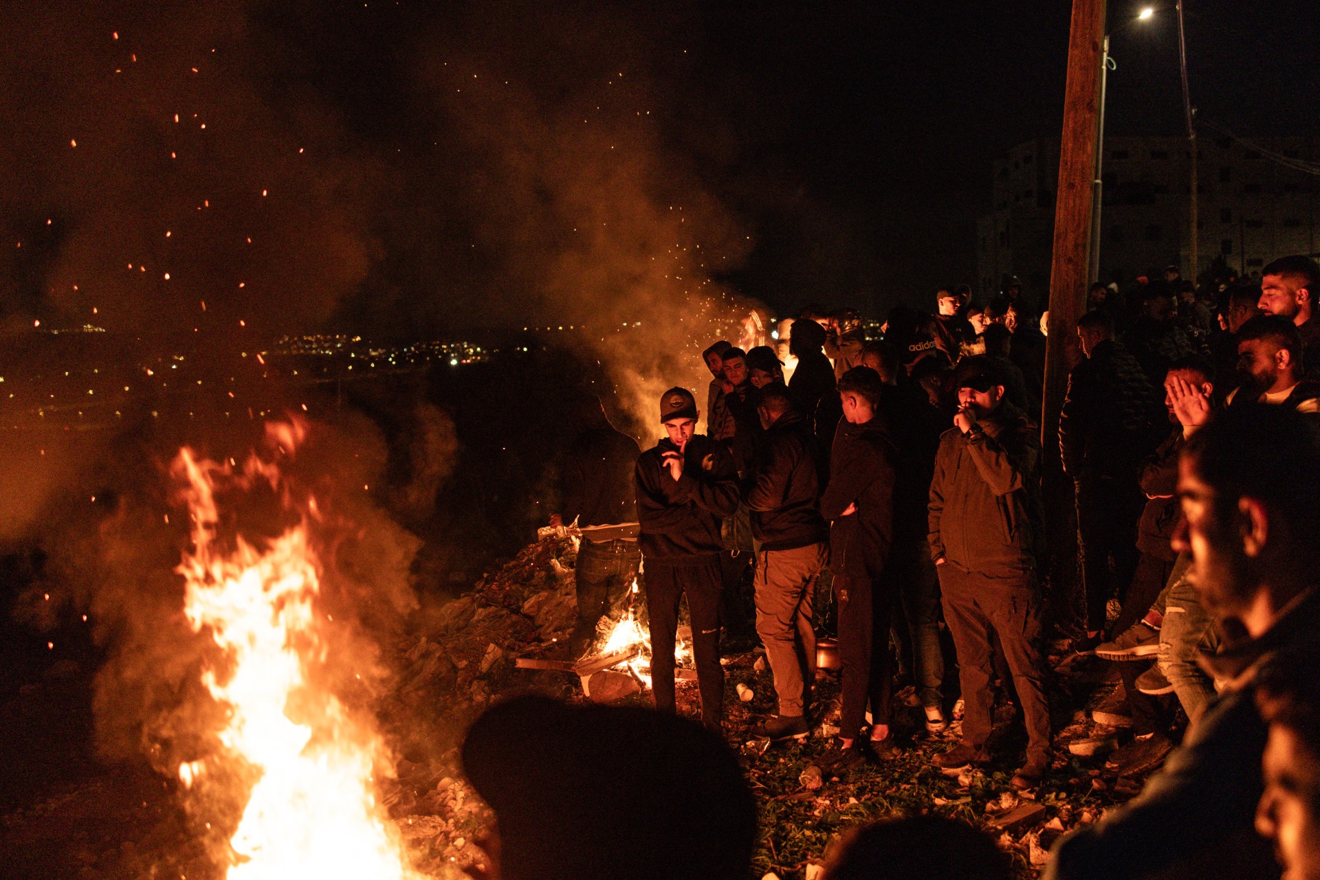 families wait around bonfires ofer prison west bank