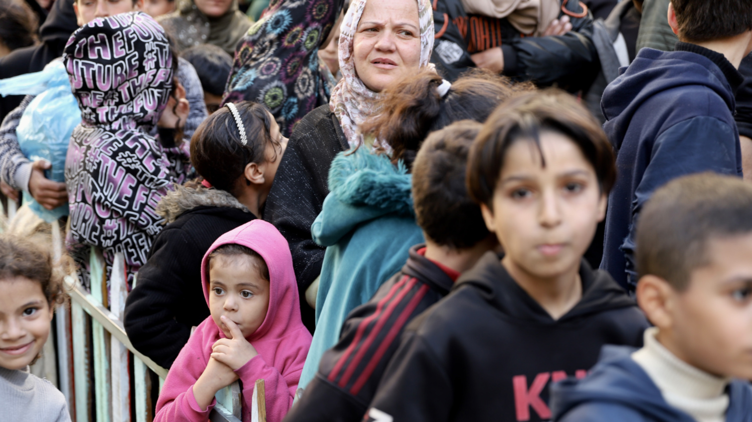 People lining up for food distributions in Gaza City (Mohammed al-Hajjar/MEE)
