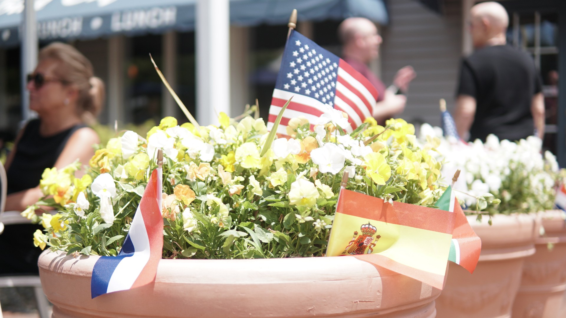 Mini-decorative country flags in pot plants outside a cafe in Basking Ridge (Azad Essa/MEE)