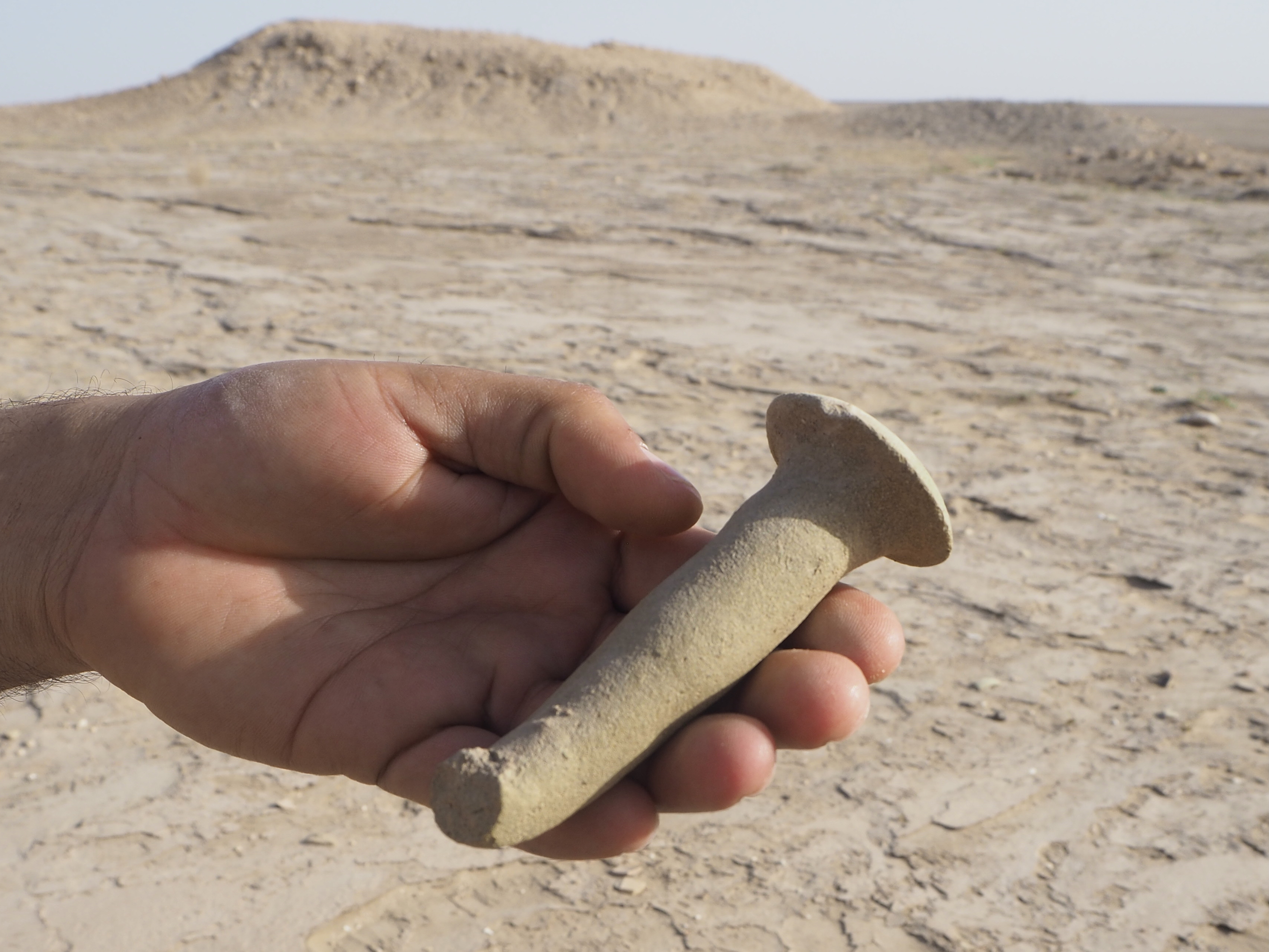 Pottery items resembling nails, used as part of elegant wall decorations in ancient times, are scattered about at Eridu 