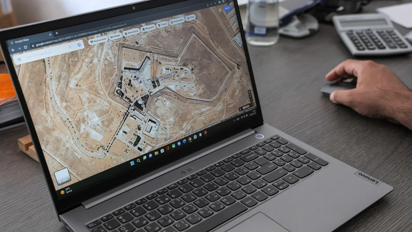 Diab Serriya of the Association of Detainees and The Missing in Sednaya Prison views a satellite image of the prison on Google Maps from Turkey on 12 August 2022 (AFP)