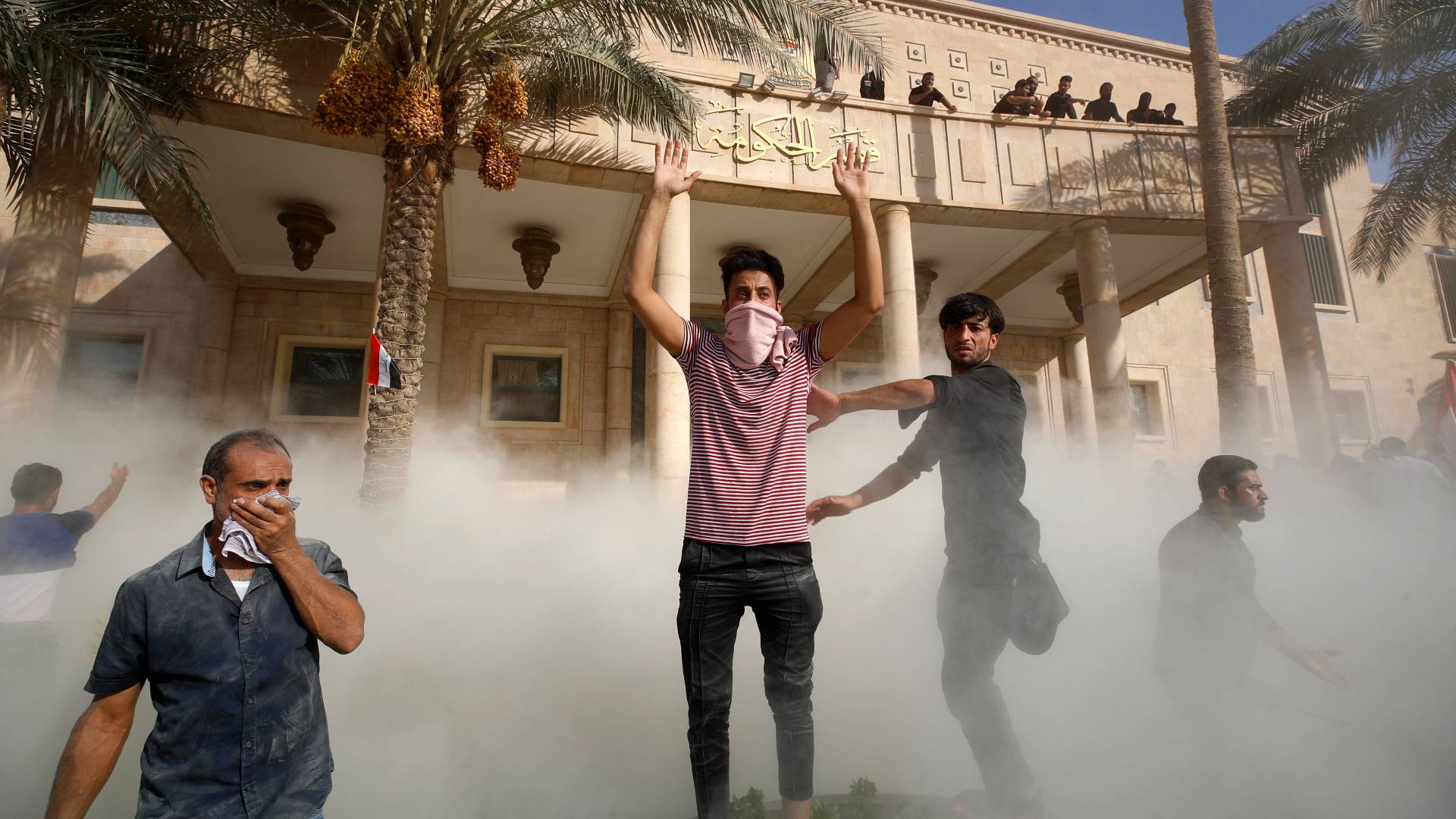 Protesters gather outside and on the balcony of the Government Headquarters in the capital Baghdad's Green Zone.