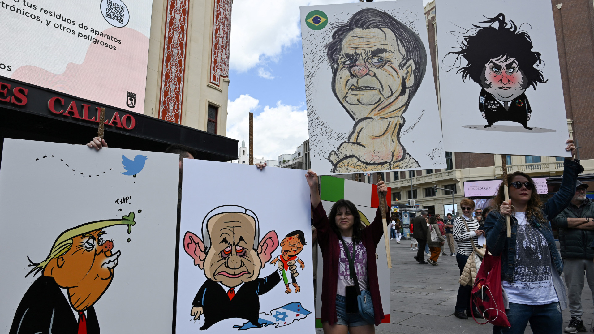 Protesters hold signs depicting, from left, former US President Donald Trump, Israeli Prime Minister Benjamin Netanyahu, former Brazilian President Jair Bolsonaro, and Argentine President Javier Milei during a demonstration against a gathering of Spanish far-right party Vox in Madrid on 18 May 2024 (Javier Soriano/AFP)
