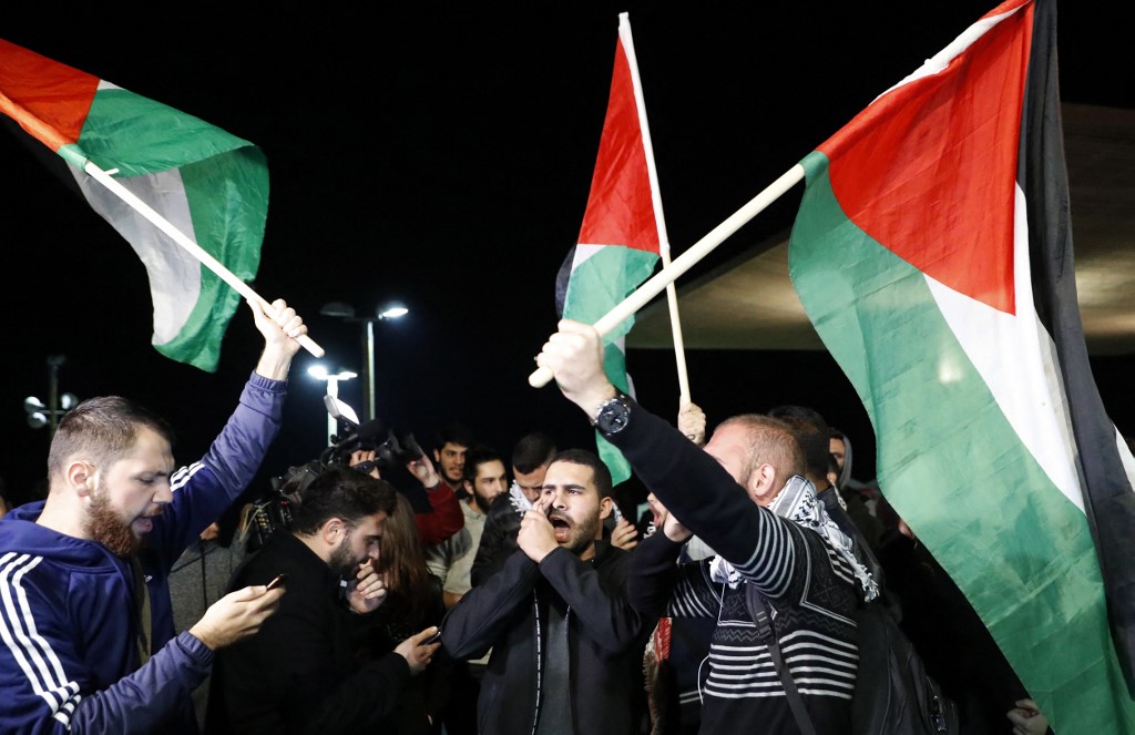 Arab-Israeli protesters in Tel Aviv denounce then-US President Donald Trump’s decision to recognise Jerusalem as the capital of Israel in December 2017 (AFP)