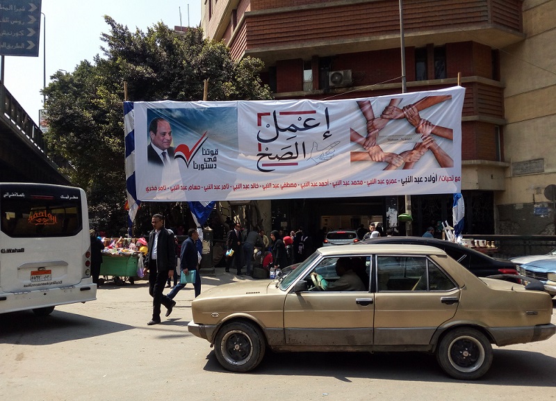 'Tick the box' says the campaign poster in Cairo which lists around 10 names of those who presumably sponsored the banner (MEE)