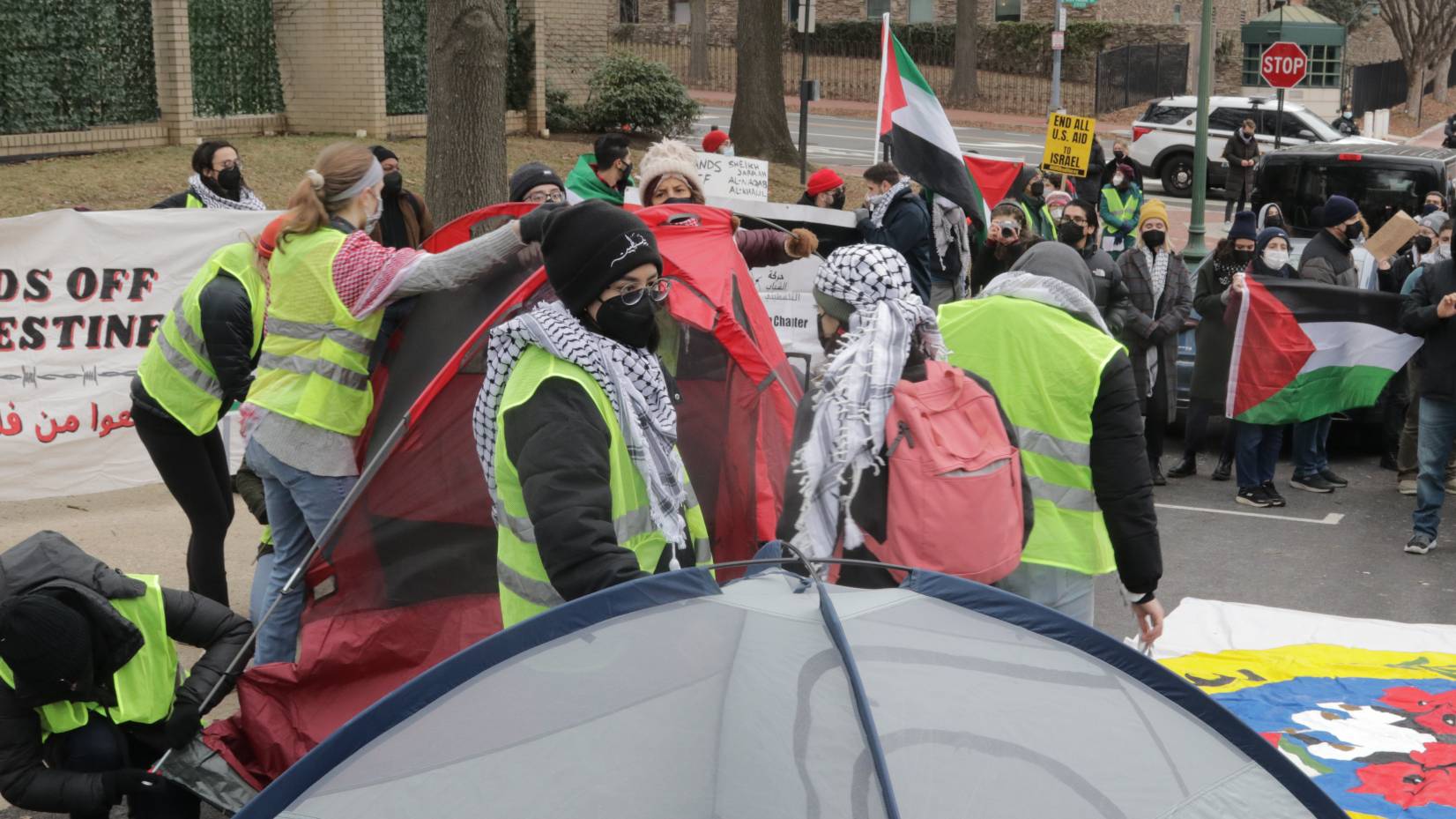 Protesters stand together ahead of a sit in at the gate of the Israeli embassy in Washington.