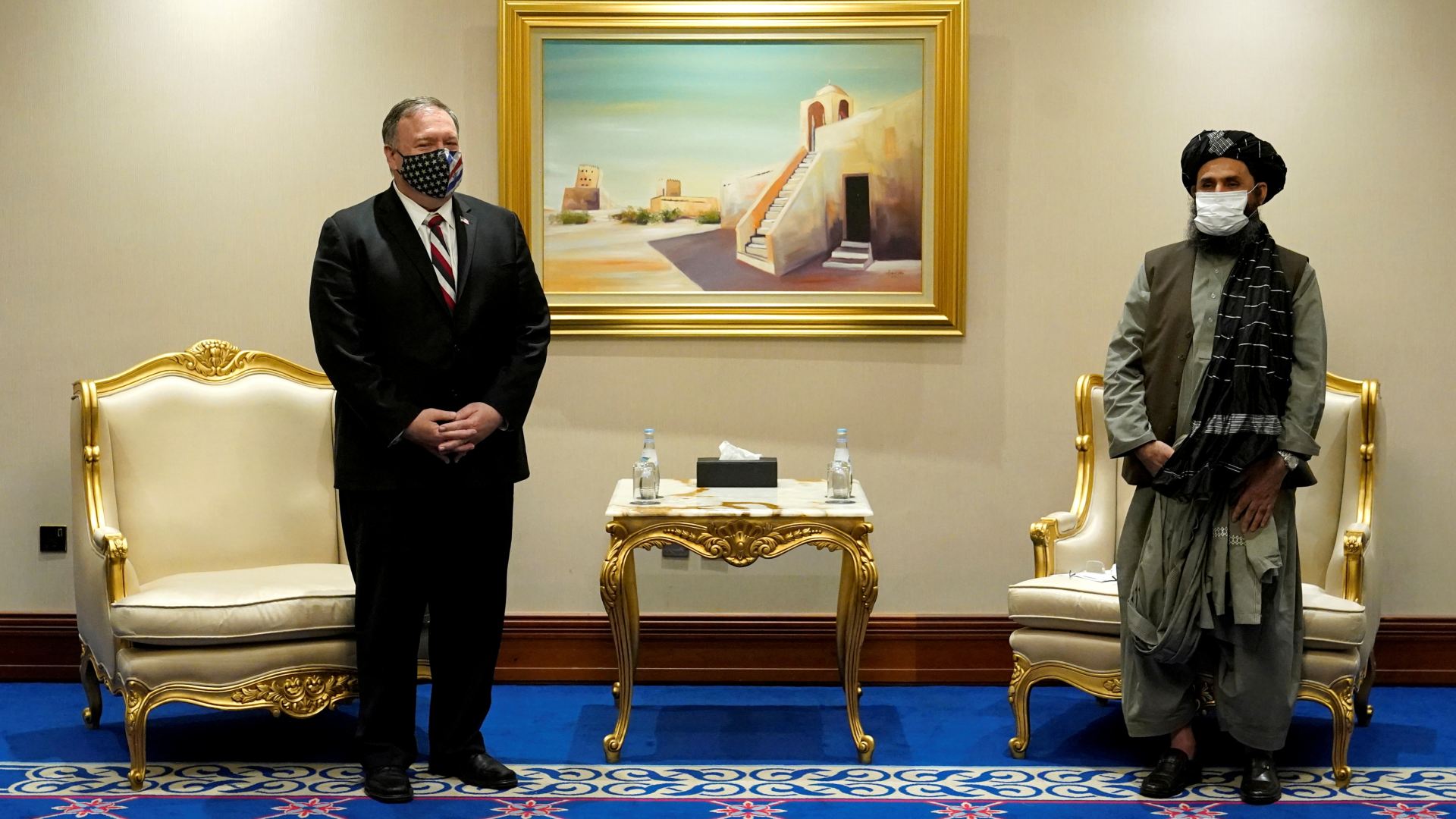 US Secretary of State Mike Pompeo meets with Taliban chief negotiator Mullah Abdul Ghani Baradar in Doha in November 2020 (Reuters)