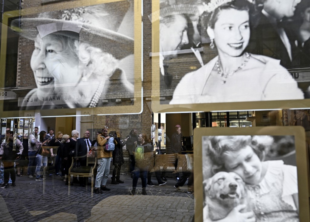 Members of the public queue to pay their respects to the Queen, lying-in-state at Westminster Abbey in London, on 16 September 2022 (AFP)