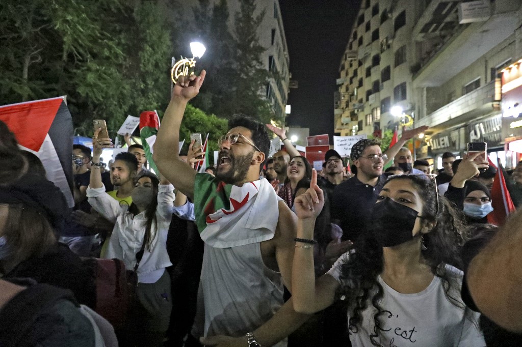 Palestinians protest in the occupied West Bank city of Ramallah on 9 May 2021 (AFP)