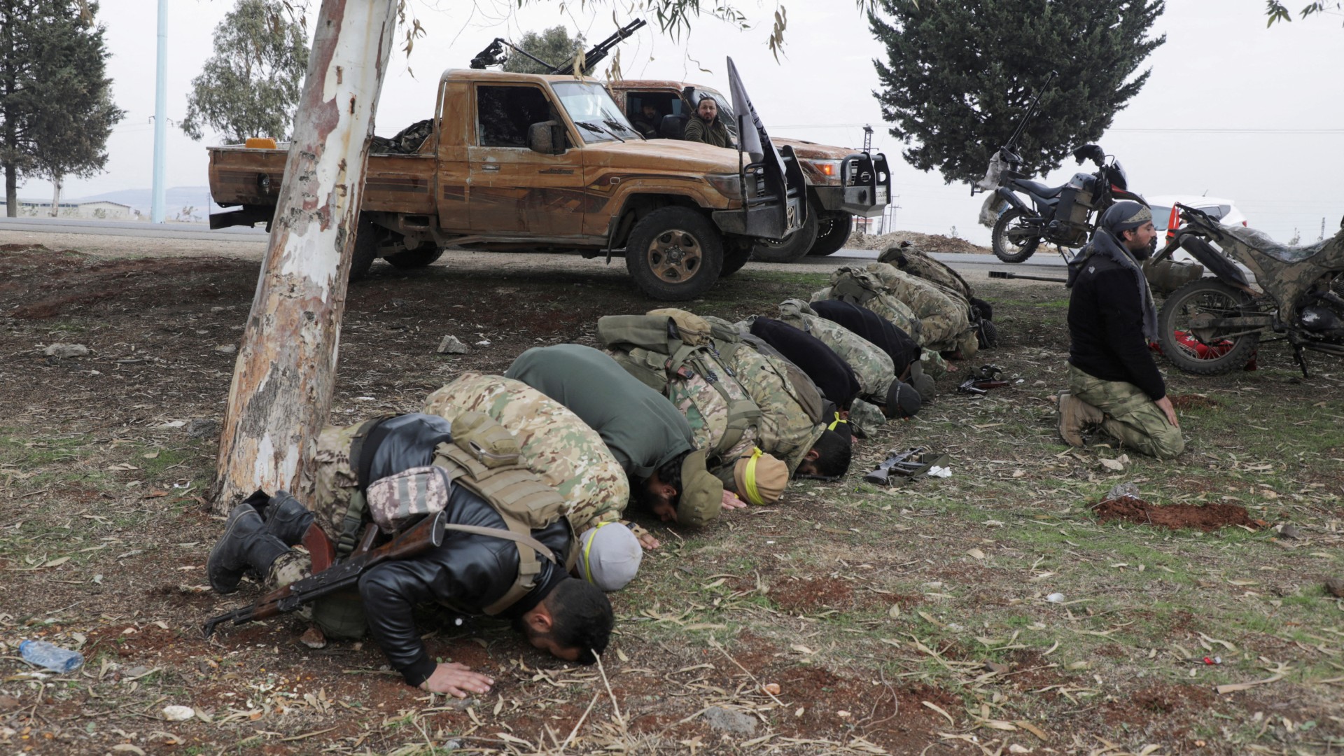 Rebel fighters pray in Homs countryside on 7 December (Reuters/Mahmoud Hasano)