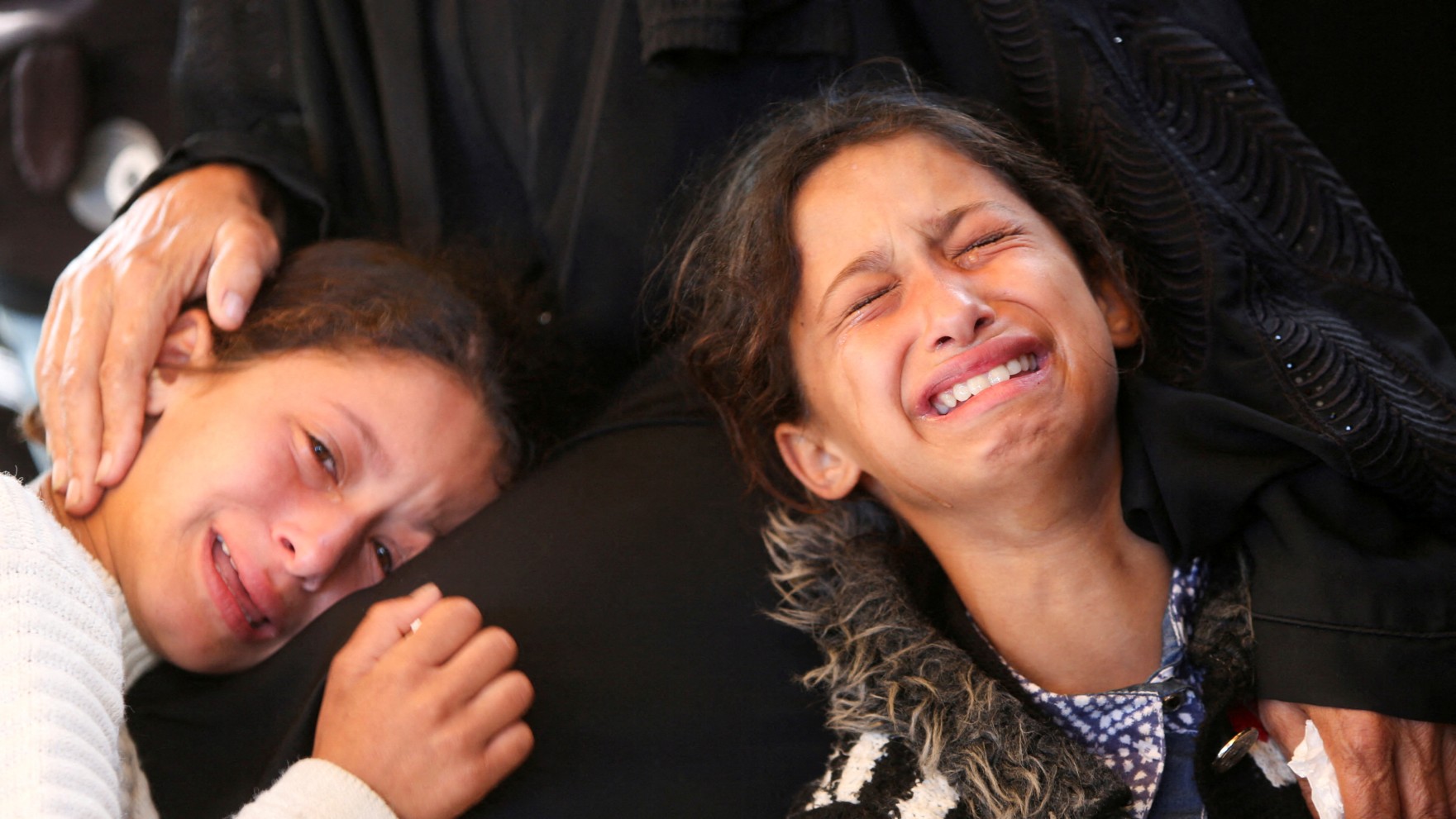 Girls react during the funeral of Palestinians who, according to medics, were killed in Israeli strikes, at Nasser hospital, in Khan Younis, in the southern Gaza Strip, June 2, 2025. REUTERS/Hatem Khaled TPX IMAGES OF THE DAY