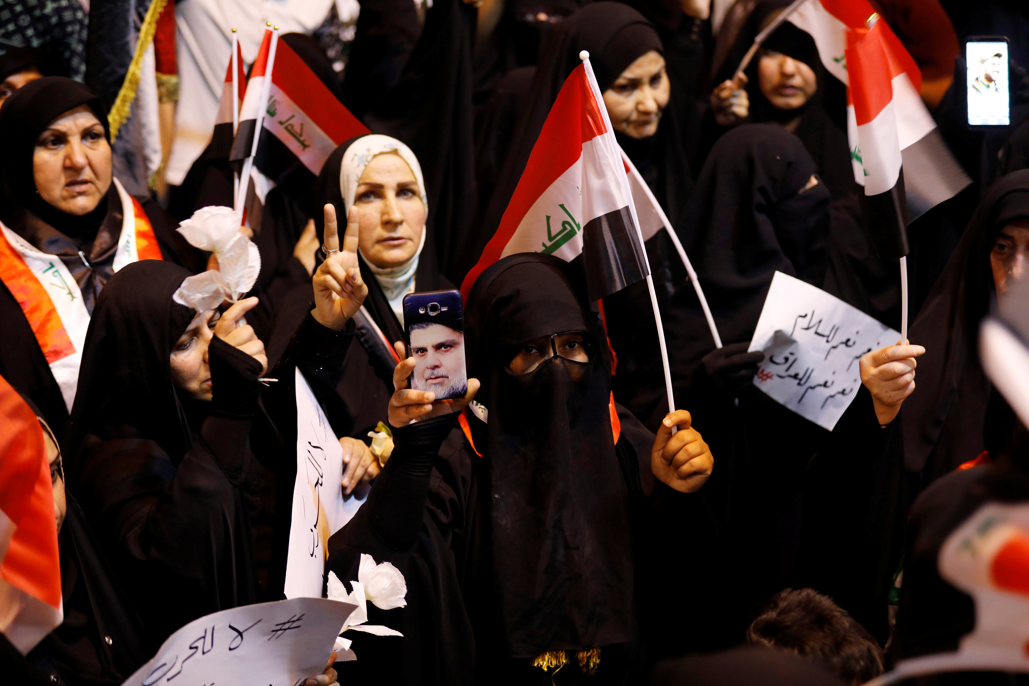 A supporter of Iraqi cleric Moqtada al-Sadr shows the victory sign during protest calling for neutrality (Reuters)