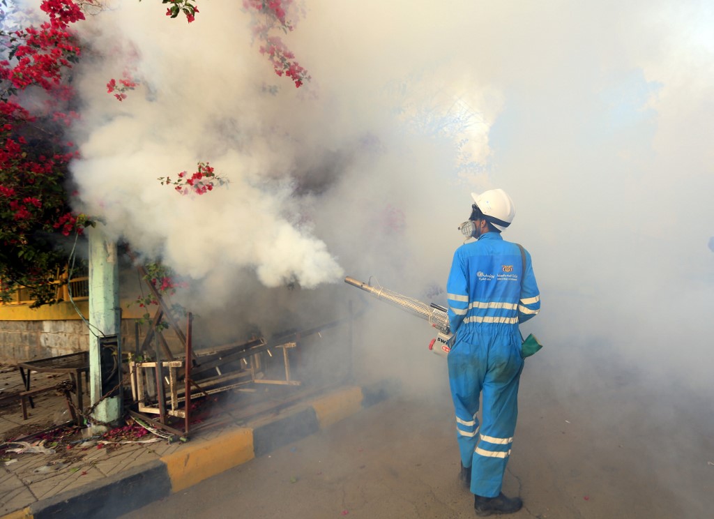 A municipal worker sprays cholera antiseptics in the Yemeni capital of Sanaa, on June 7, 2018