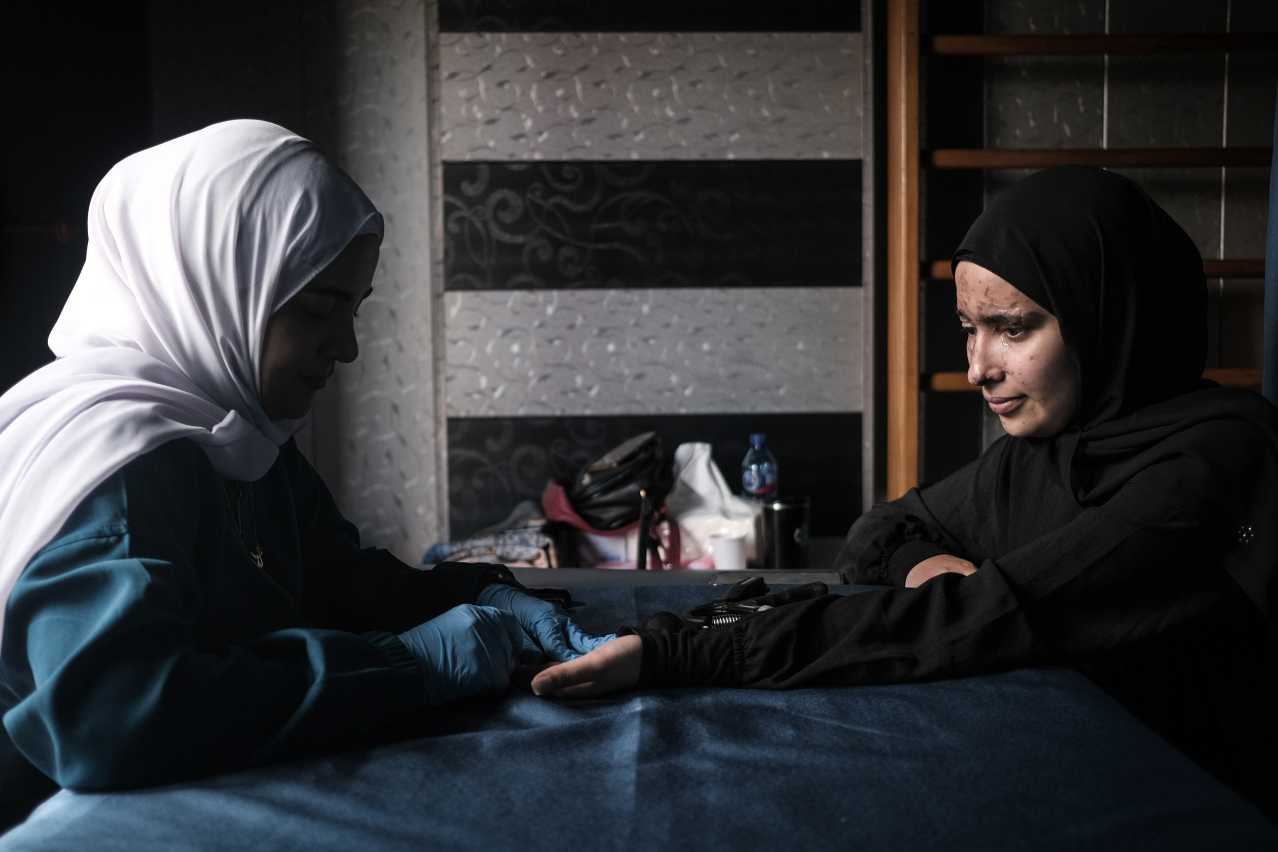 Sarah Jaffal sits across her physiotherapist during their regular sessions to rehabilitate her strength and dexterity after being seriously wounded by a pager's explosion (João Sousa/MEE)