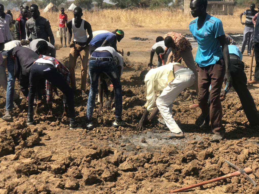 Villagers dig a mass grave to bury the dead (MEE/Jan-Peter Westad)