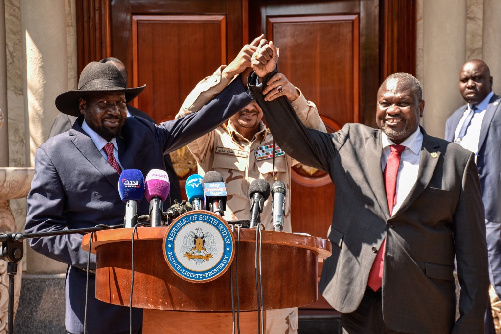 South Sudanese President Salva Kiir, opposition leader Riek Machar and Hemeti speak to the media after peace talks in Juba on 17 December (AFP)
