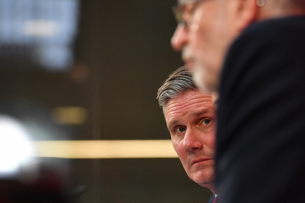 Former Labour leader Jeremy Corbyn speaks with Starmer in London in 2019 (AFP)