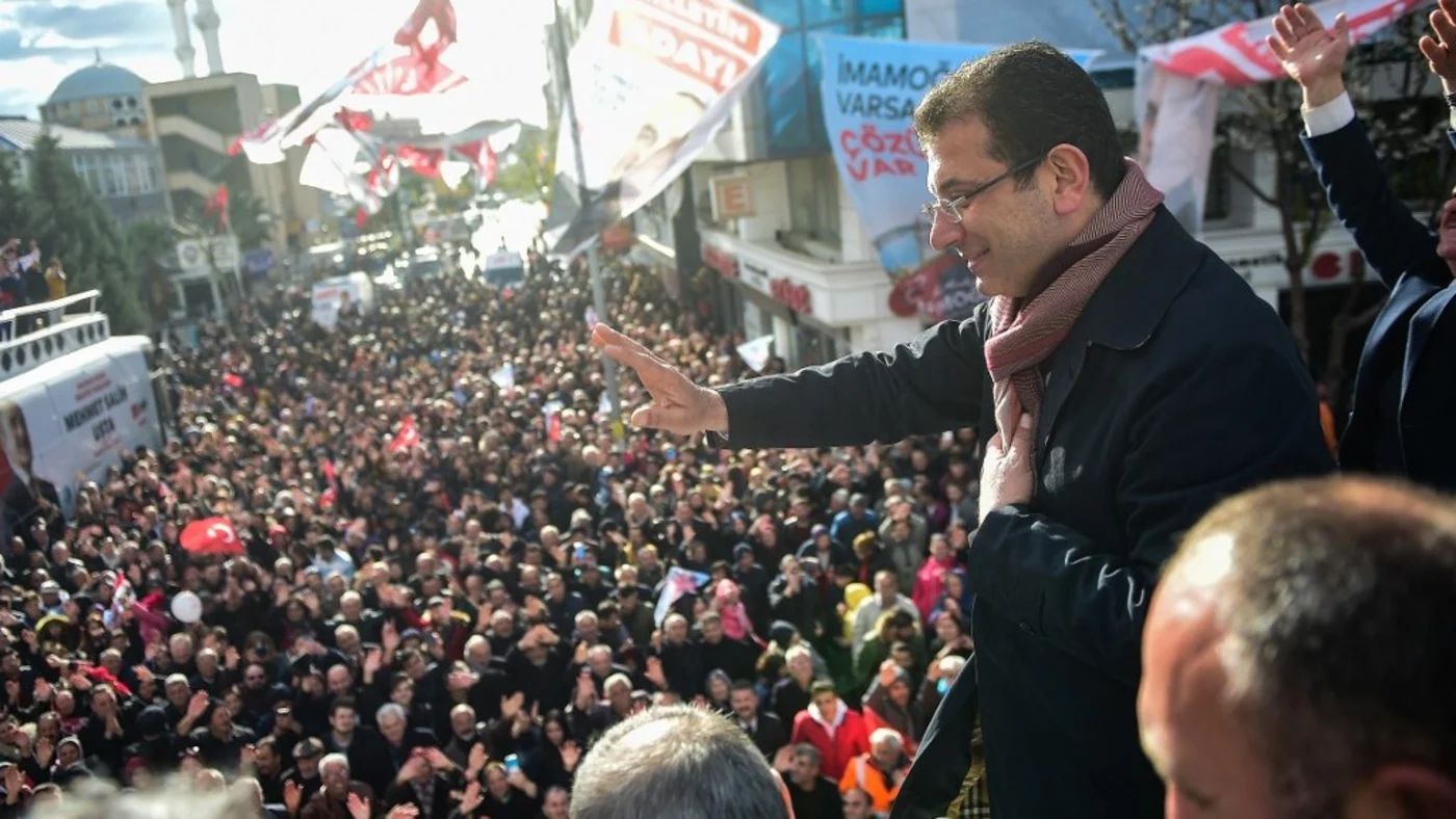 Candidate of main opposition Republican People's Party (CHP) for Istanbul mayor Ekrem Imamoglu (R) greets his supporters during a rally ahead of the upcoming local elections, in Istanbul (AFP)