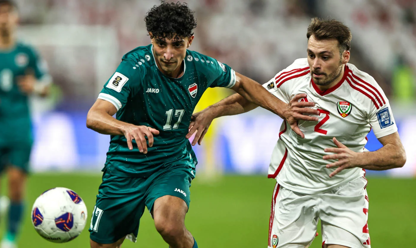 Iraq's Ali Jasim vies for the ball with UAE's defender during the FIFA World Cup 2026 Asian qualifier football match in Abu Dhabi on 13 November 2025 (AFP)