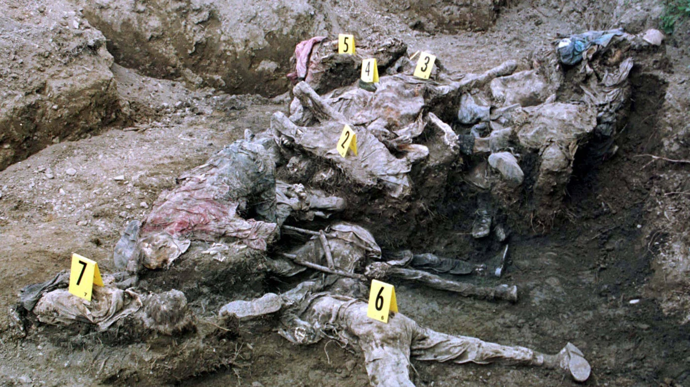 The bodies of Muslim men and boys uncovered in a mass grave near the eastern Bosnian village of Nova Kasaba on 24 July 1996 (Reuters).
