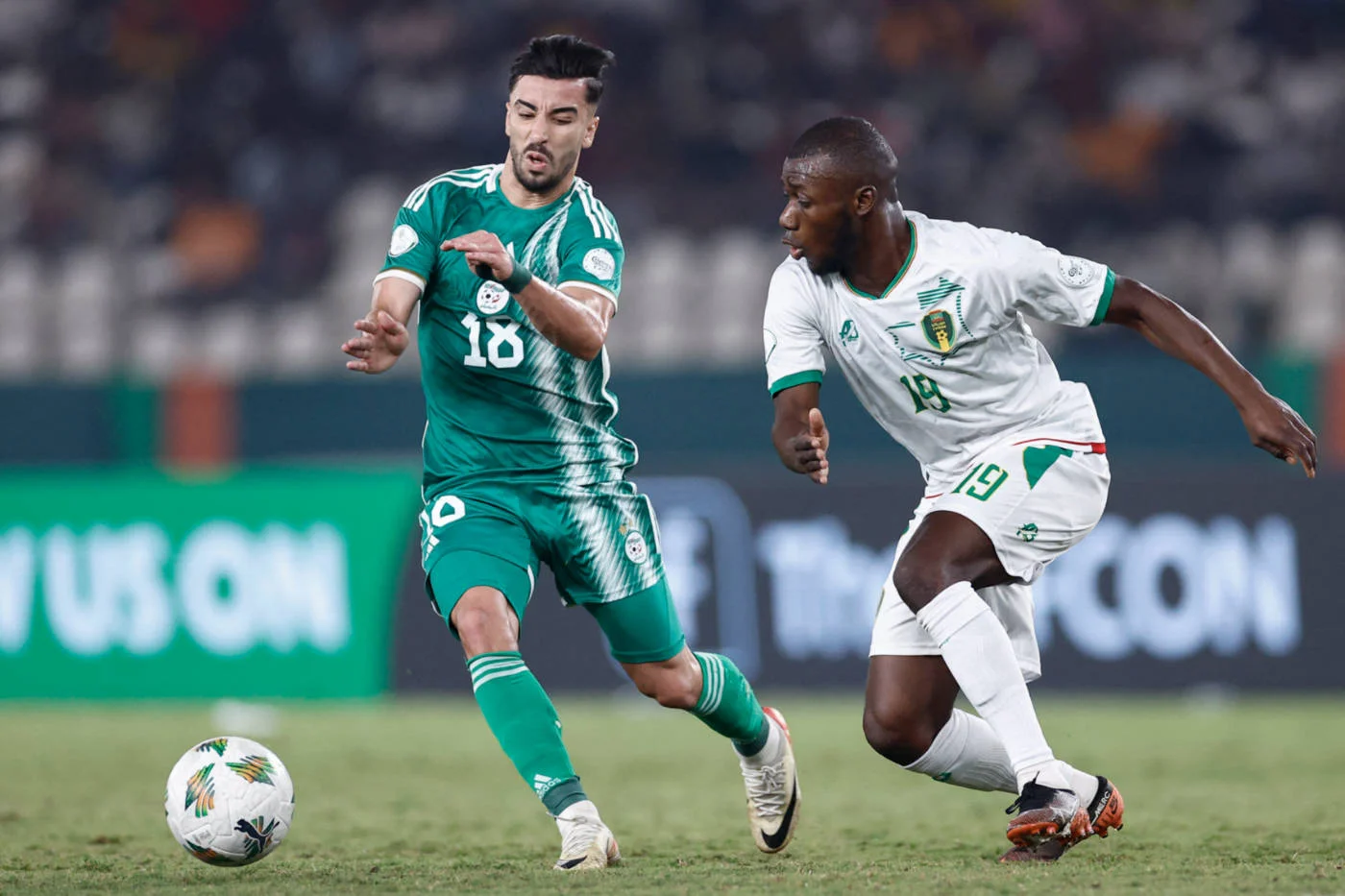 Algeria's Mohamed Amoura fights for the ball with Mauritania's Aboubakary Koita during the Africa Cup of Nations (CAN) 2024 group D football match in Bouake on 23 January 2024 (AFP)