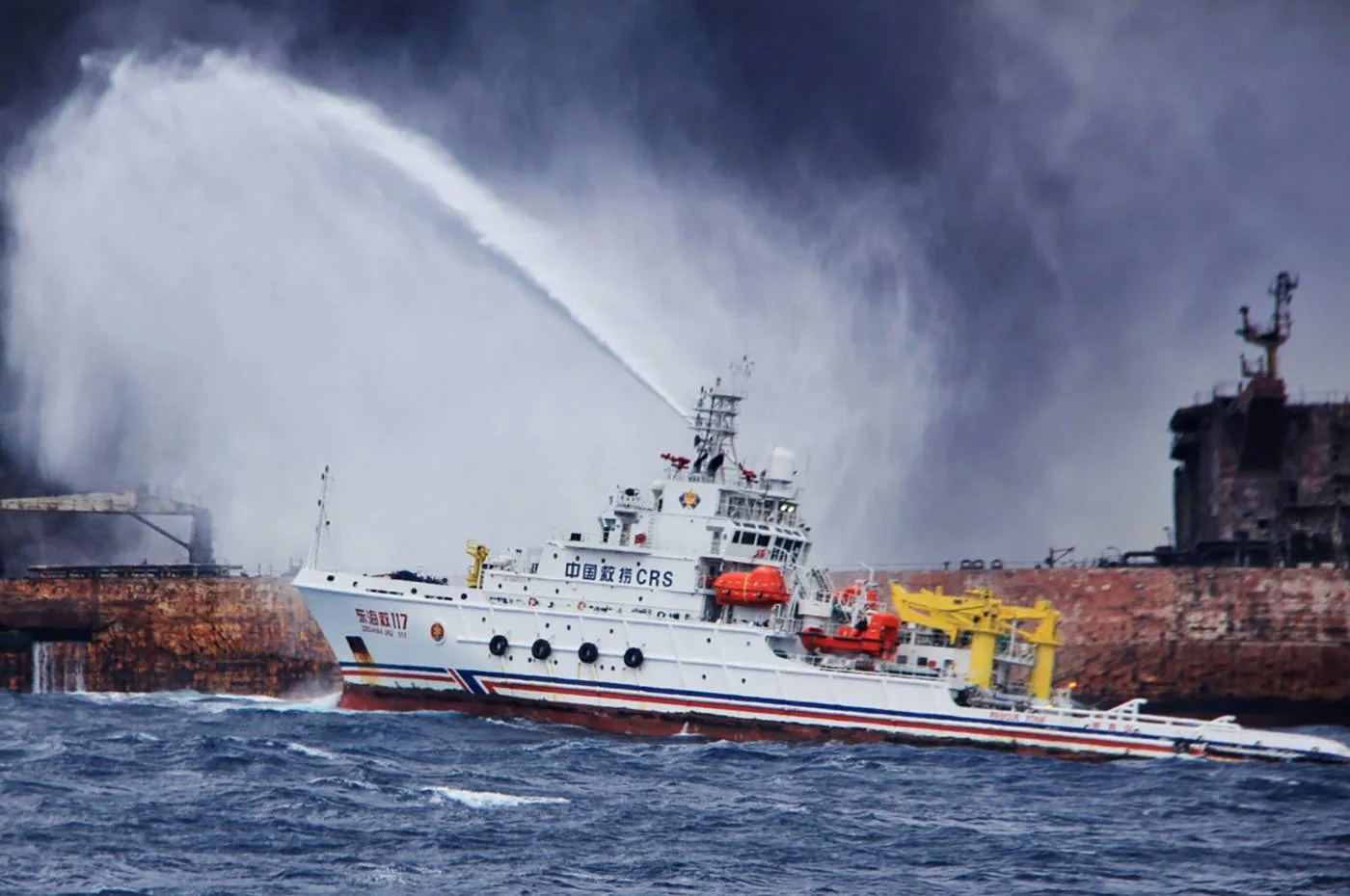 A Chinese firefighting vessel sprays water on the burning oil tanker Sanchi off the coast of eastern China in January 2018 (AFP/Transport Ministry of China handout)