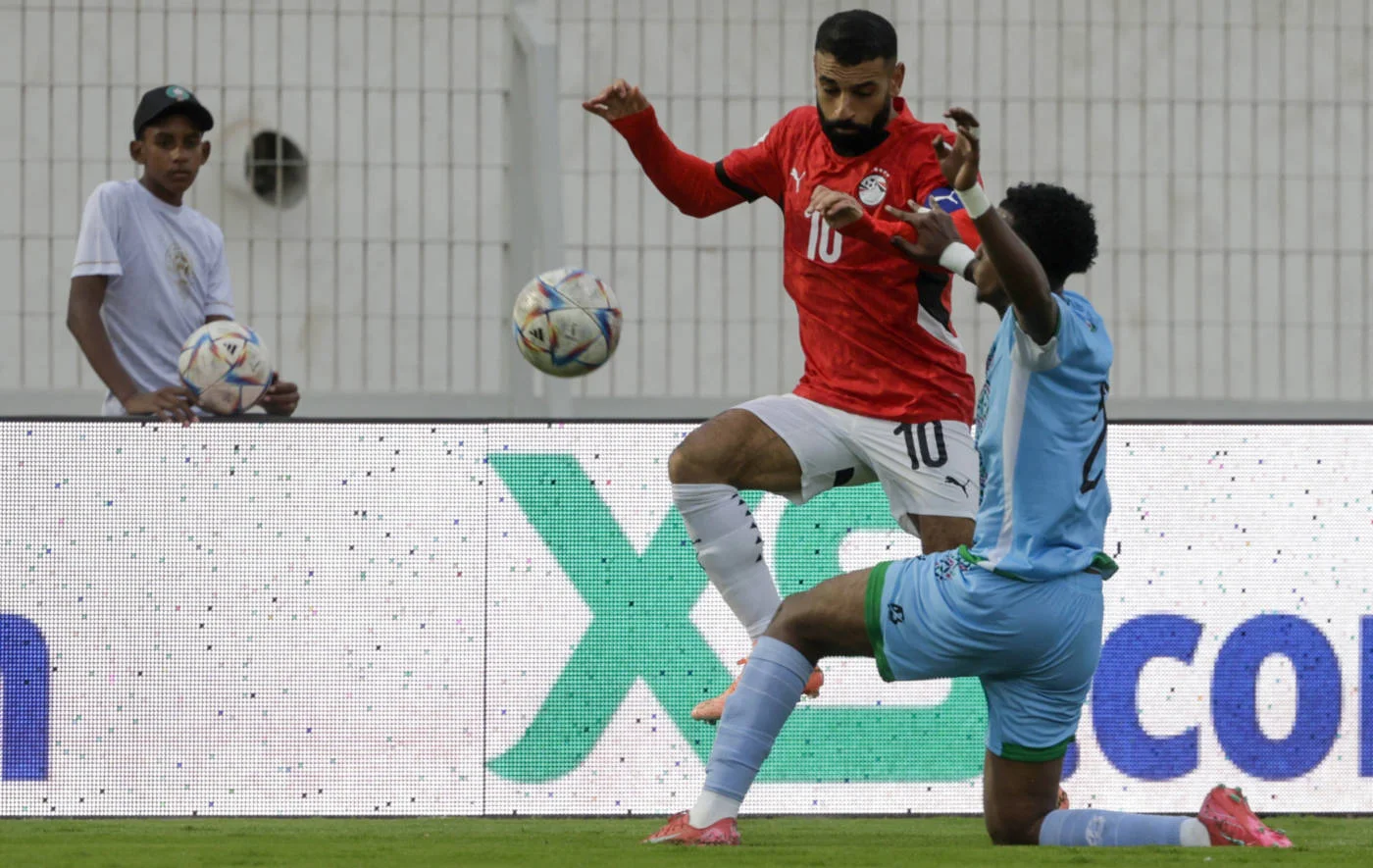 Egypt's Mohamed Salah is marked by Djibouti's Aboubaker Liban Abdi during the FIFA World Cup 2026 Africa qualifier football match in Casablanca on 8 October 2025 (AFP)