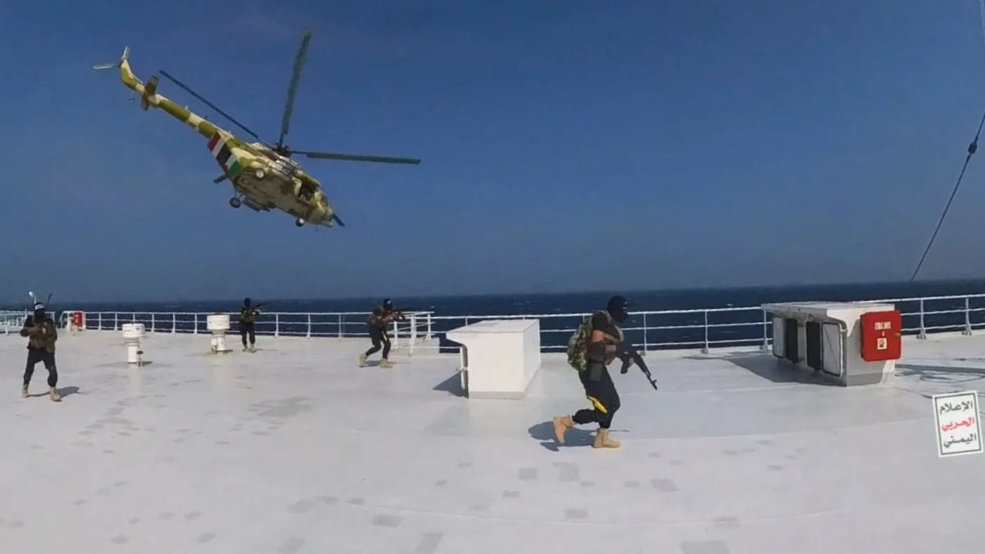 A Houthi military helicopter hovers over the Galaxy Leader cargo ship in the Red Sea as the vessel is boarded by Houthi fighters in November 2023 (Houthi Military/Reuters) 