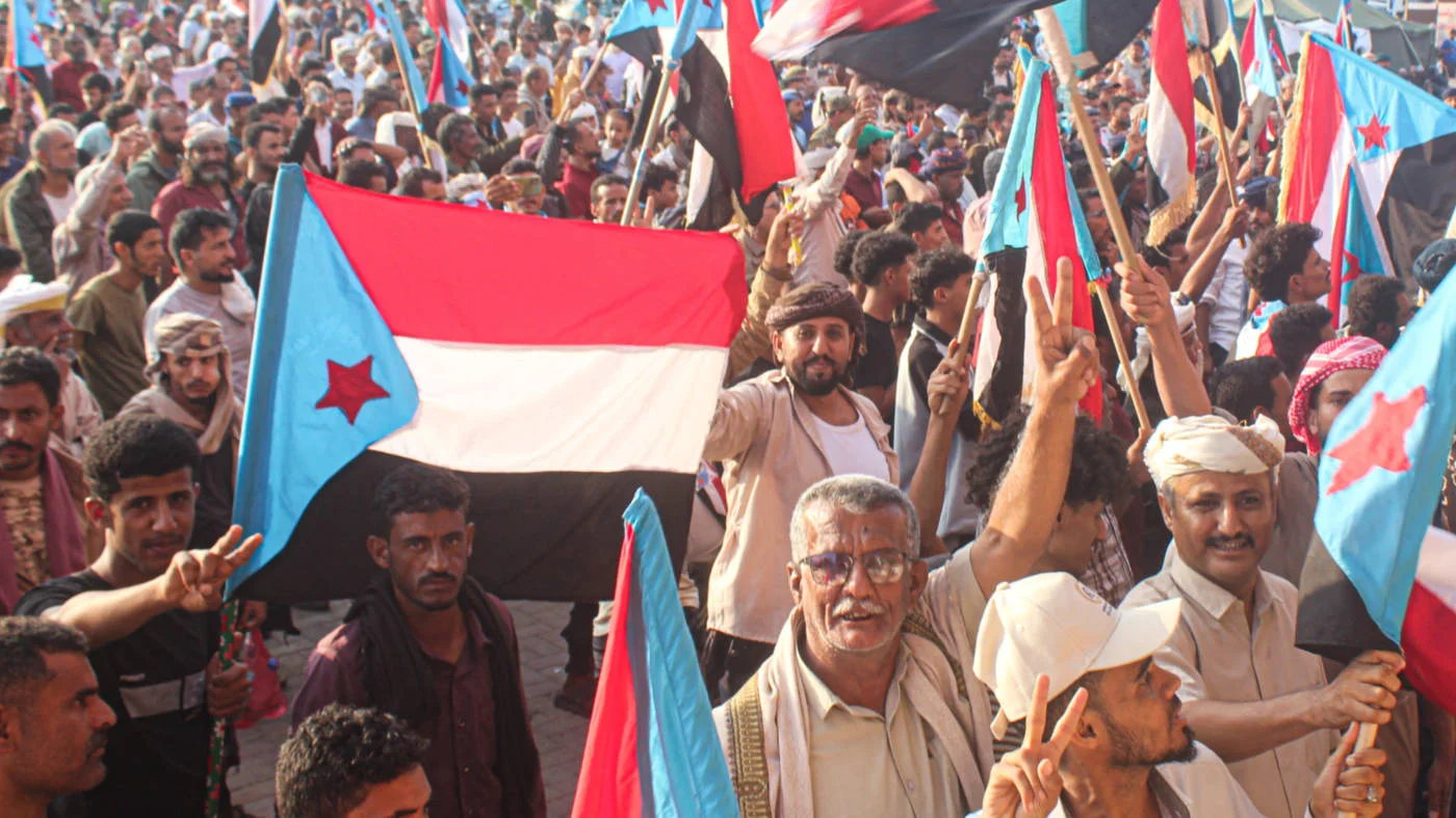 Yemenis supporters of the UAE-backed Southern Transitional Council (STC) wave the old South Yemen flag, as they rally in Al-Aroud Square, Aden on 8 December 2025 (AFP)