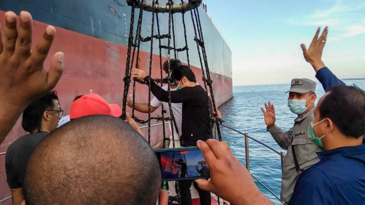 Crew from the Iranian tanker MT Horse board their ship in May 2021 before leaving Indonesian waters after their vessel was seized and a court case concluded (AFP/Indonesia Maritime Security Agency)