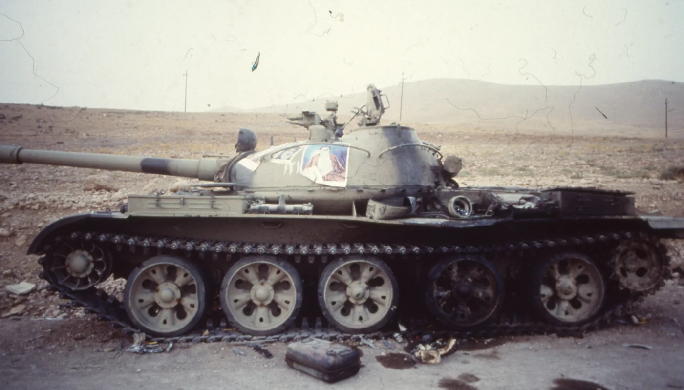 A damaged Iranian tank, decorated with a portrait of Ayatollah Ruhollah Khomeini, on the Iran-Iraq border in September 1980 (AFP)