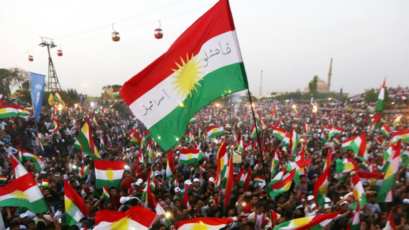Iraqi Kurds fly Kurdish flags in Erbil during the independence referendum on 16 September 2017 (AFP)