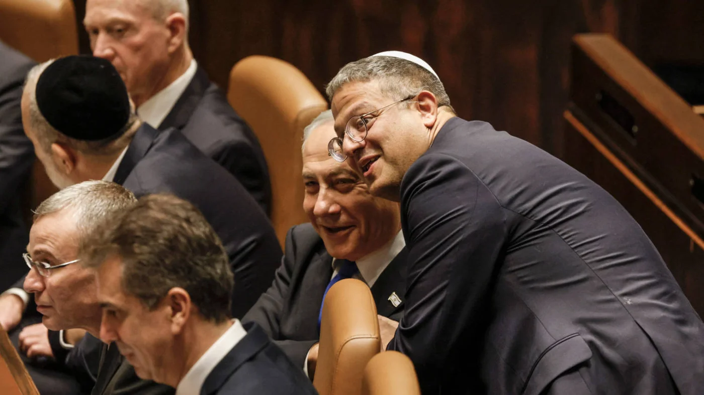 Itamar Ben-Gvir, right, congratulates Prime Minister Benjamin Netanyahu as the Israeli government is sworn in on 29 December 2022 (AFP)