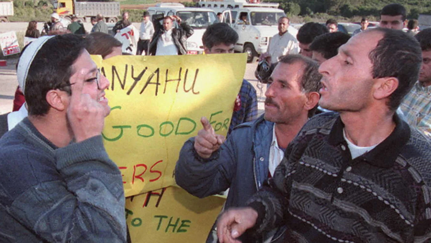 Itamar Ben Gvir holds a poster that says “Netanyahu Is good for murderers