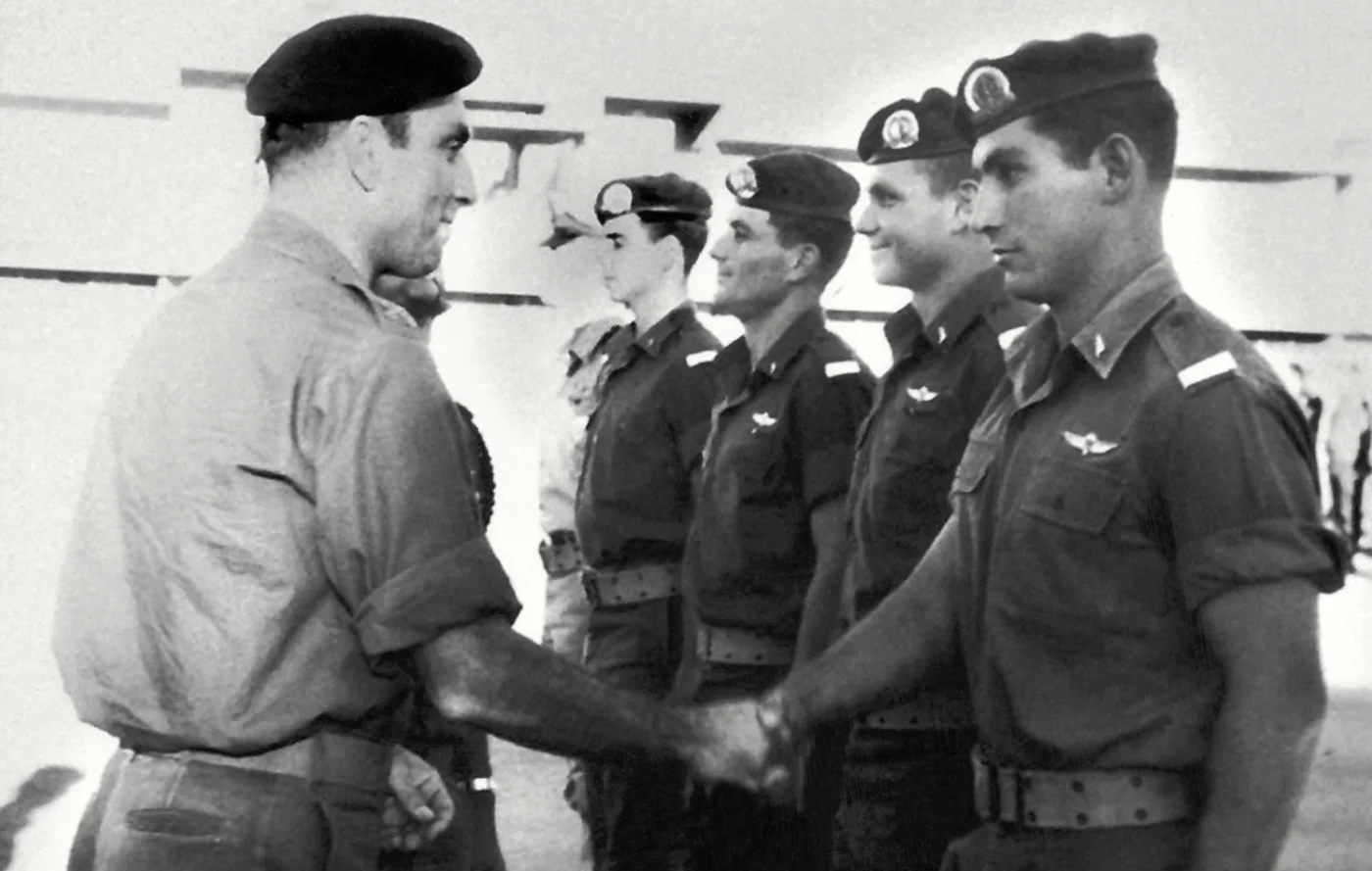 Benjamin Netanyahu, right, meets with a senior officer while on military service in Israel in 1976 (AFP)