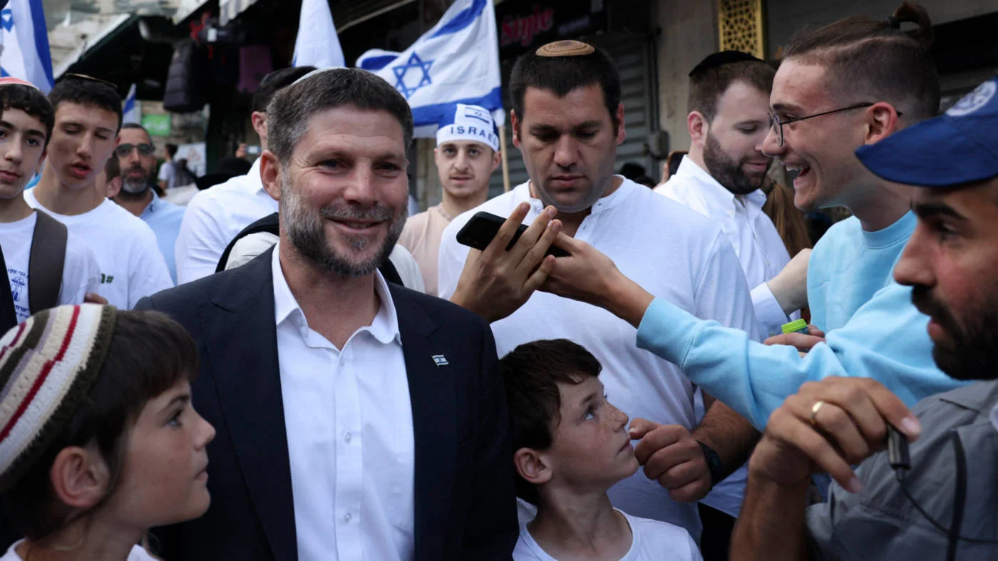 Israel's far-right Finance Minister Bezalel Smotrich, flanked by supporters, enters the Old City of Jerusalem to mark Jerusalem Day on 18 May 2023 (AFP)