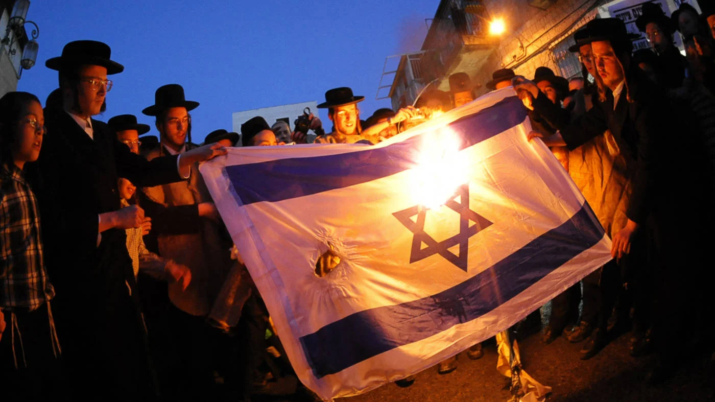 Ultra-Orthodox Jews Mea Shearim burn an Israeli flag during a demonstration against the celebrations marking Israel's 60th years anniversary in May 2008 (AFP)