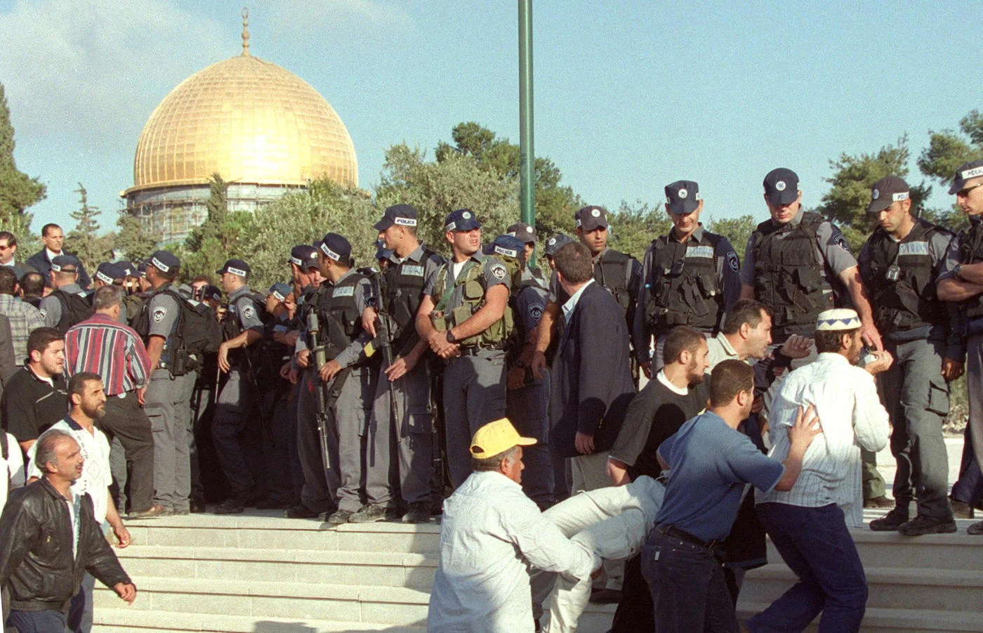 A wounded Palestinian is carried away on 28 September 2000, after Israeli police fired on protests against the visit of Ariel Sharon to Al-Aqsa in Jerusalem’s Old City (AFP)
