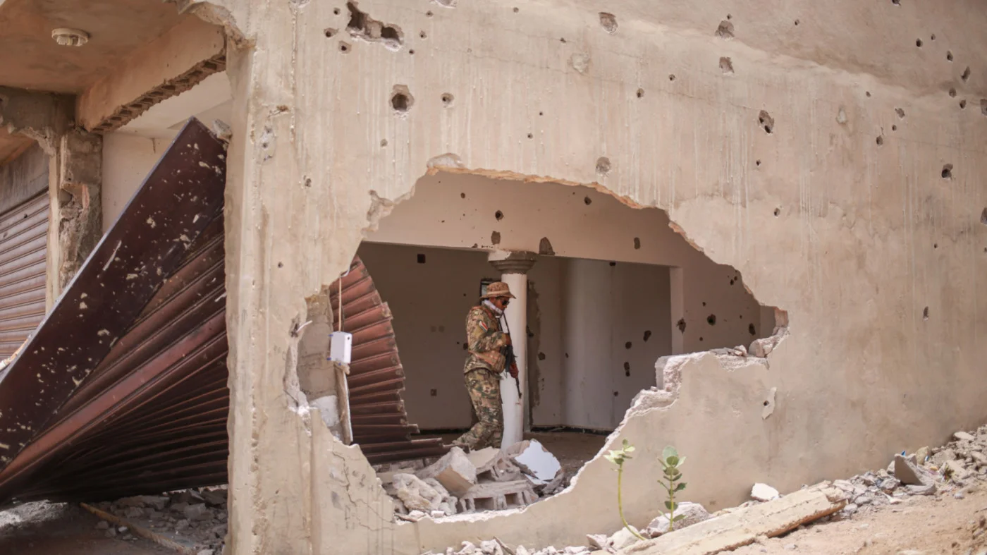 A soldier from the National Front for the Liberation of Azawad (FLA) inside a damaged building in Kidal, on 9 May 2026 (AFP)