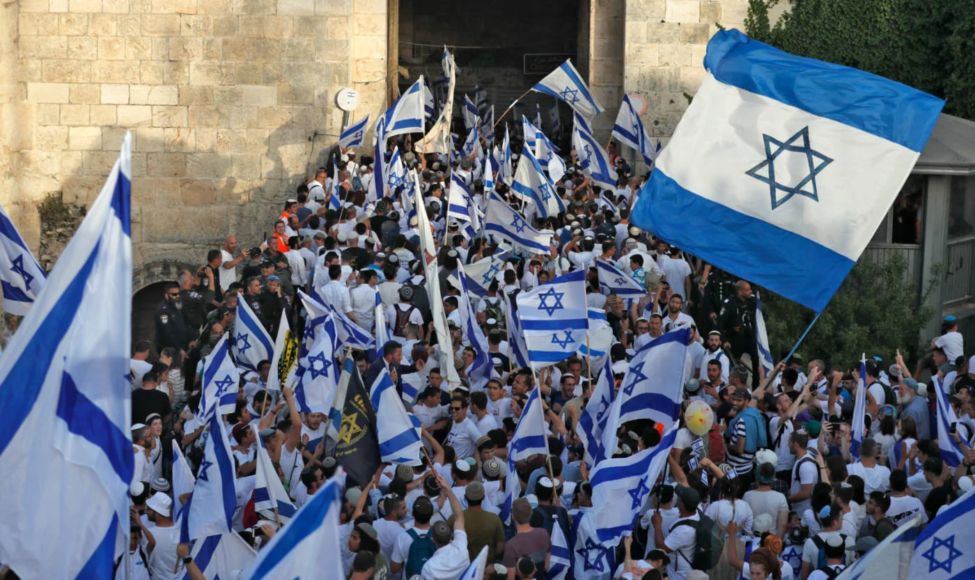 Demonstrators gather with Israeli flags at the Damascus Gate inJ erusalem in May 2022 (AFP)