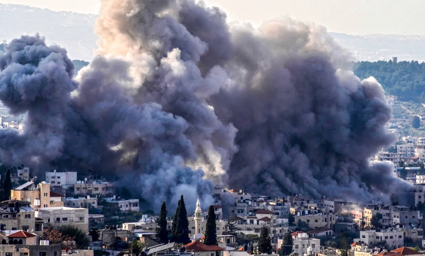 Smoke billows from a refugee camp in in February 2025 amid an Israeli offensive in the Wewst Bank (AFP)