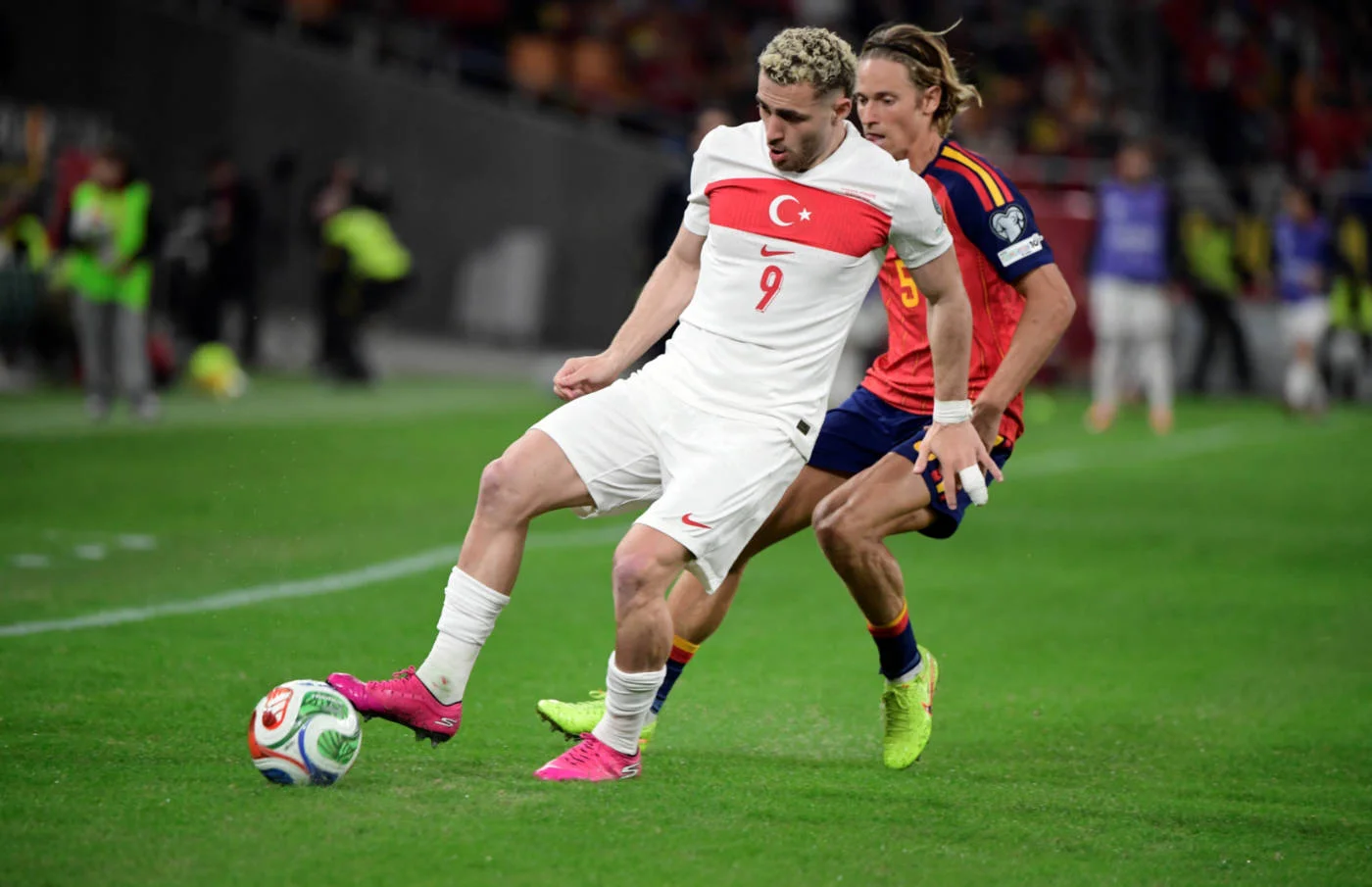 Turkey's Baris Alper Yilmaz fights for the ball with Spain's Marcos Llorente during the FIFA World Cup 2026 European qualification Group E football match in Seville on 18 November  2025 (AFP)